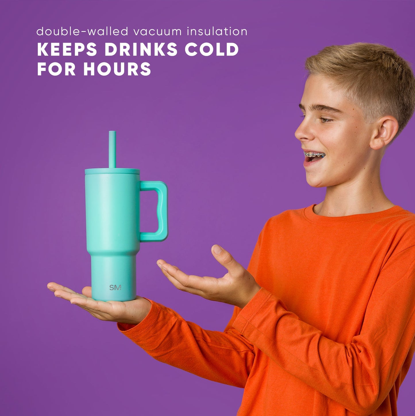 Teenager in orange shirt enthusiastically presenting a turquoise 24oz Simple Modern insulated tumbler with handle and straw against purple background. Text reads "keeps drinks cold for hours."