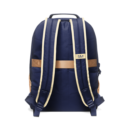 Navy blue backpack with tan and cream shoulder straps and handles